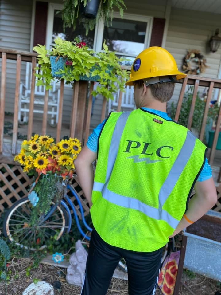 Boy in a yellow hard hat and neon vest with 
