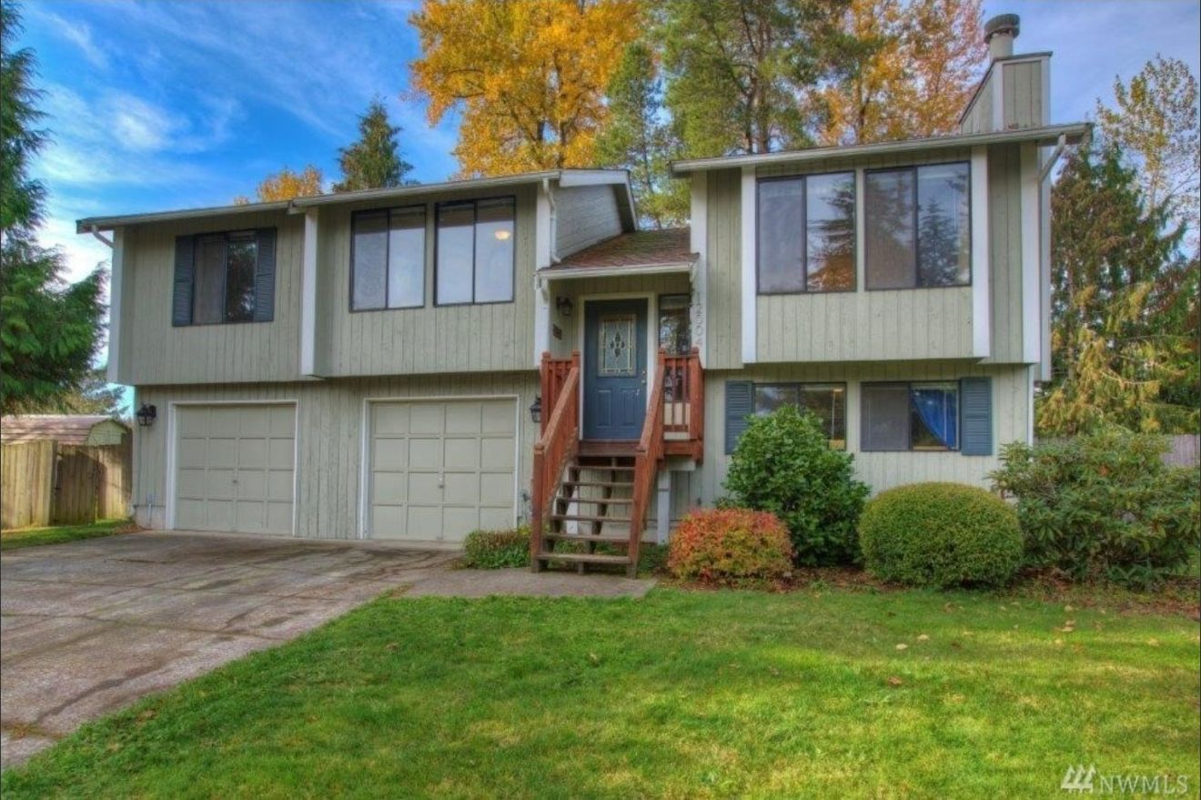 A large house with a lot of windows and a blue door