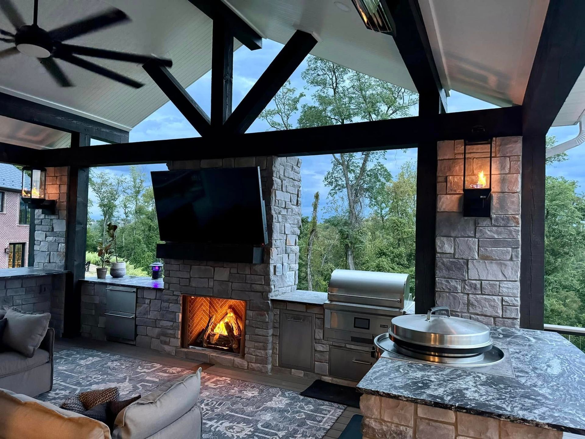 A living room with a fireplace and a television.