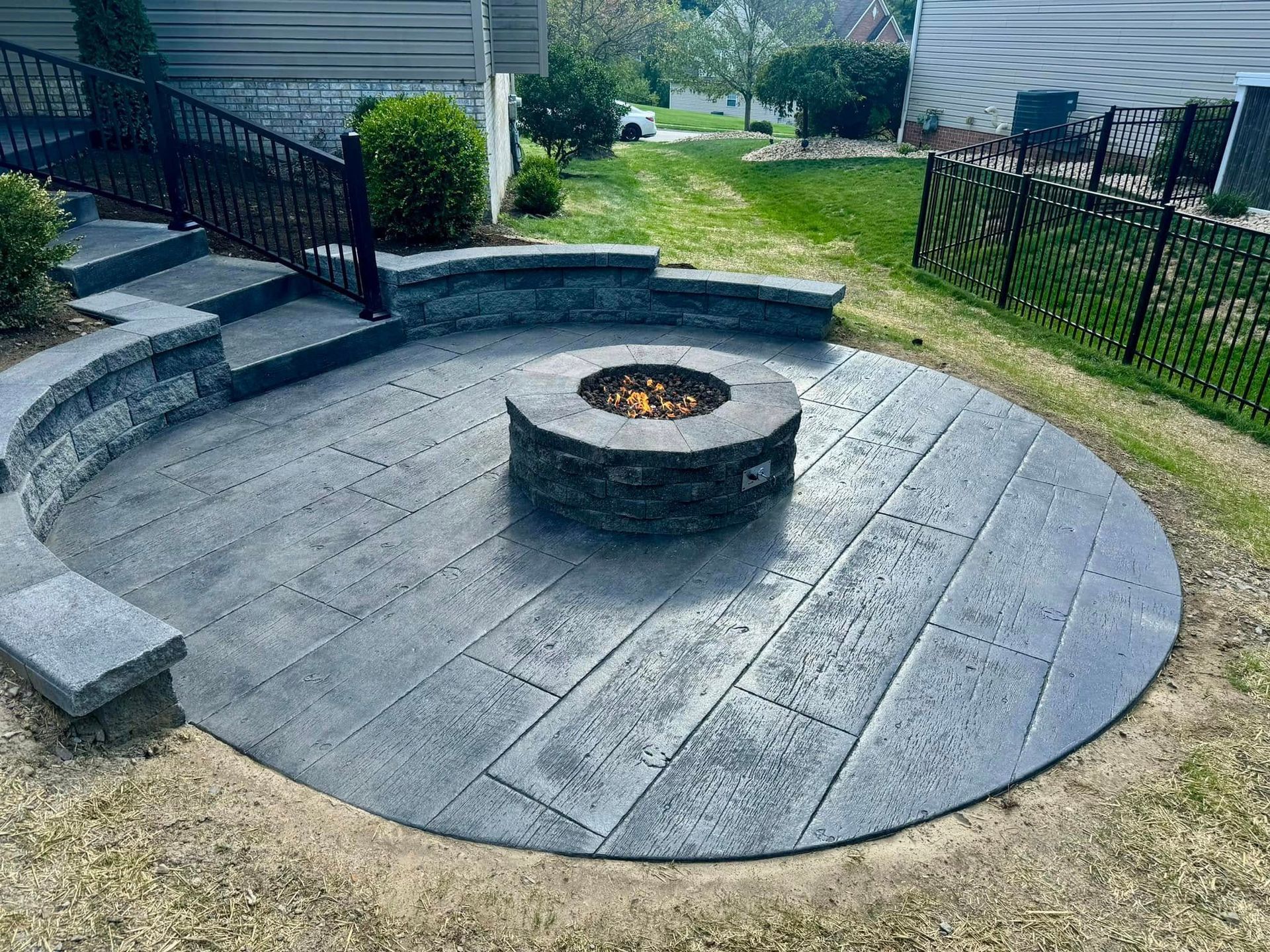 There is a fire pit in the middle of the patio.