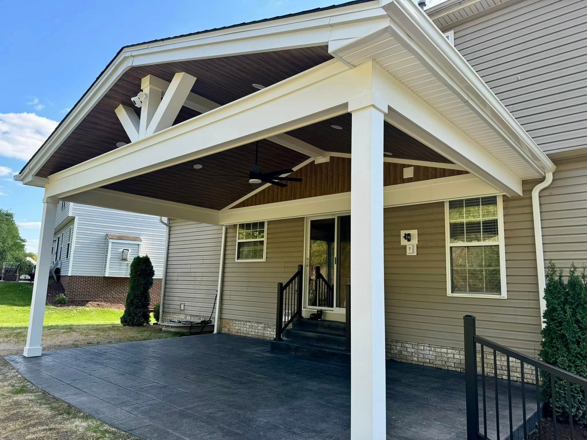 A house with a porch and a ceiling fan on it.