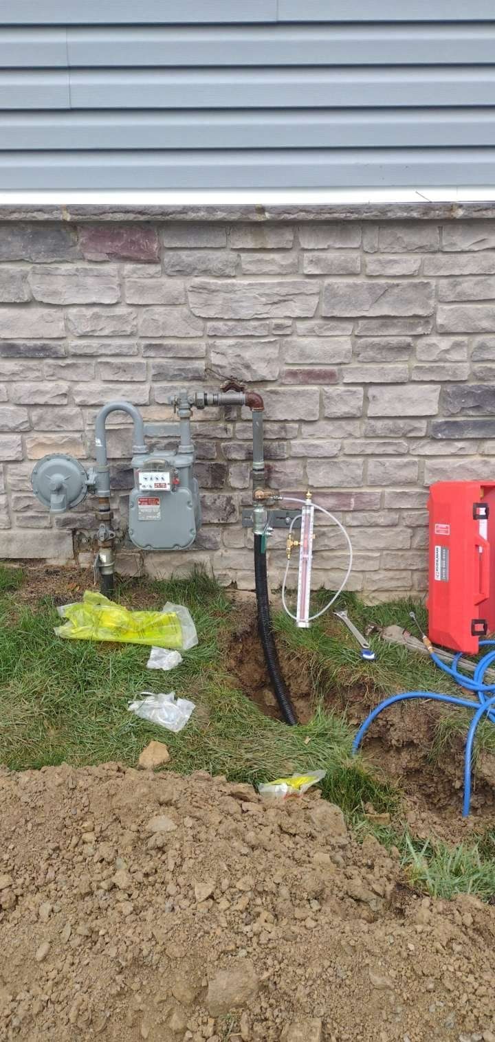 A gas meter is being installed on the side of a house.