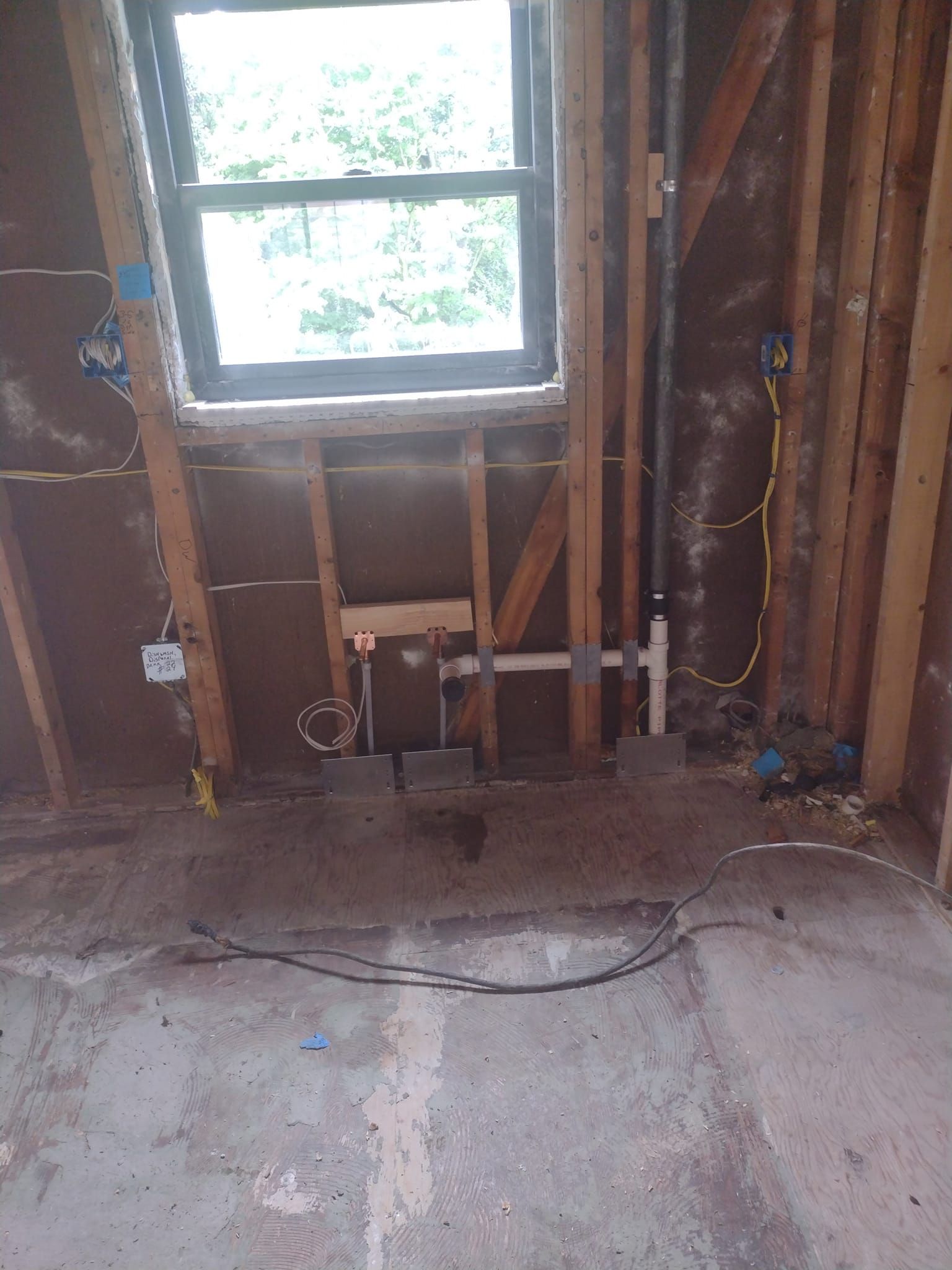 A room with a window and pipes in it.