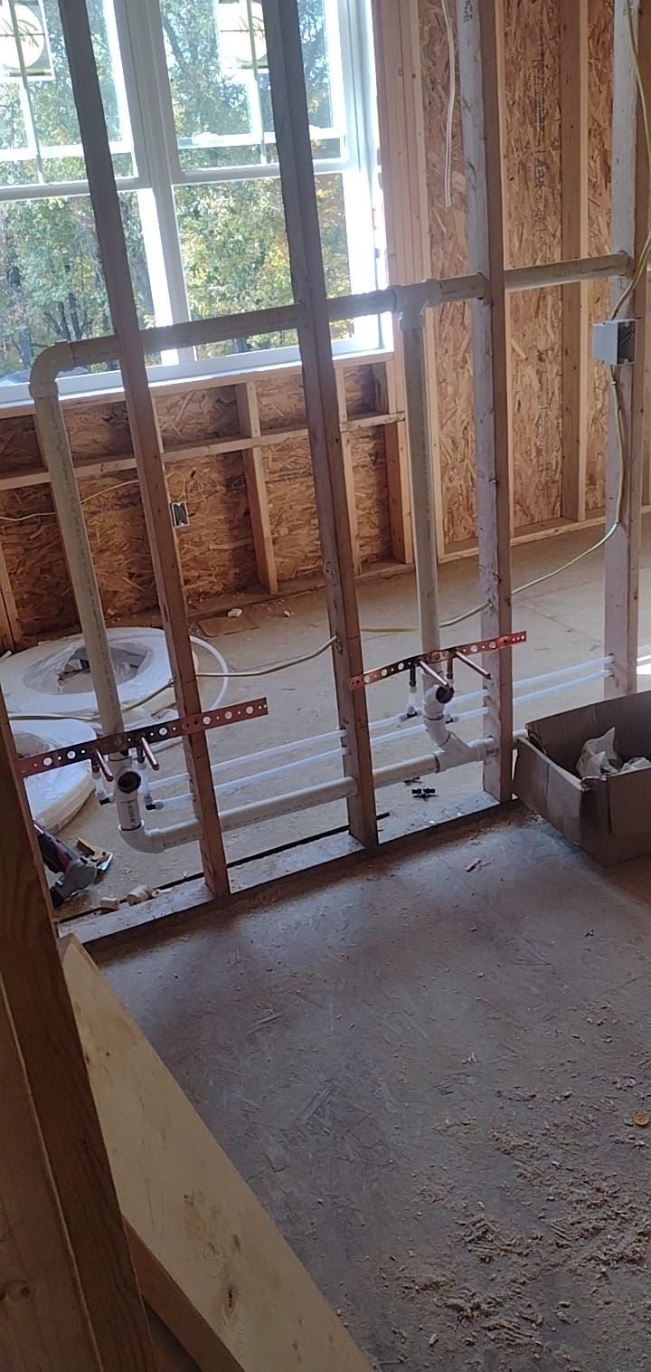 A room under construction with a window and a box on the floor.