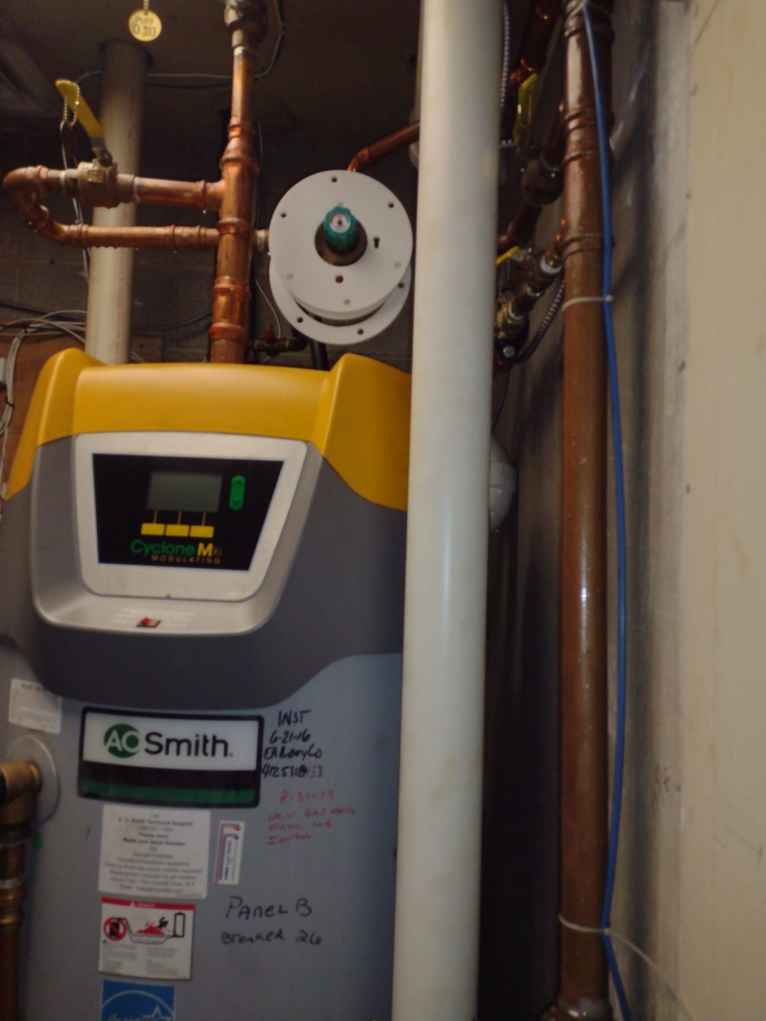 A smith water heater in a basement with copper pipes