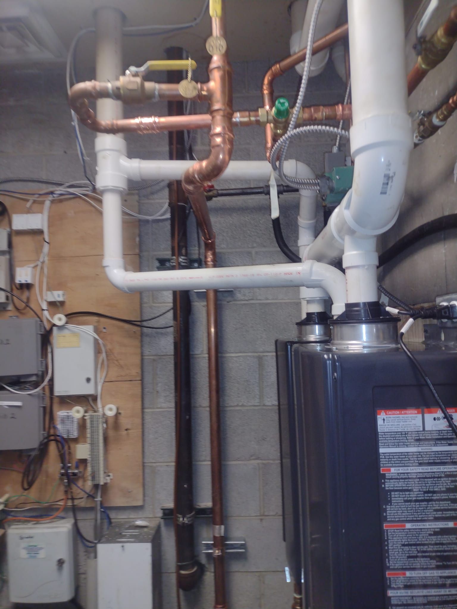 A room with a lot of pipes and a boiler