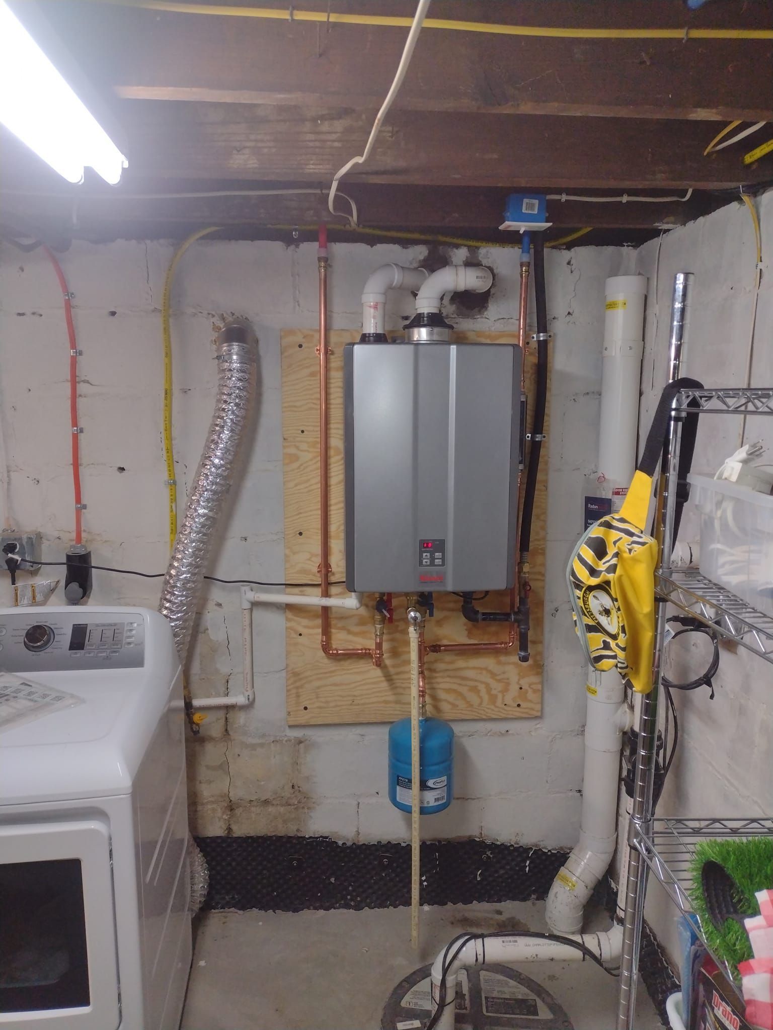 A laundry room with a washer and dryer and a water heater