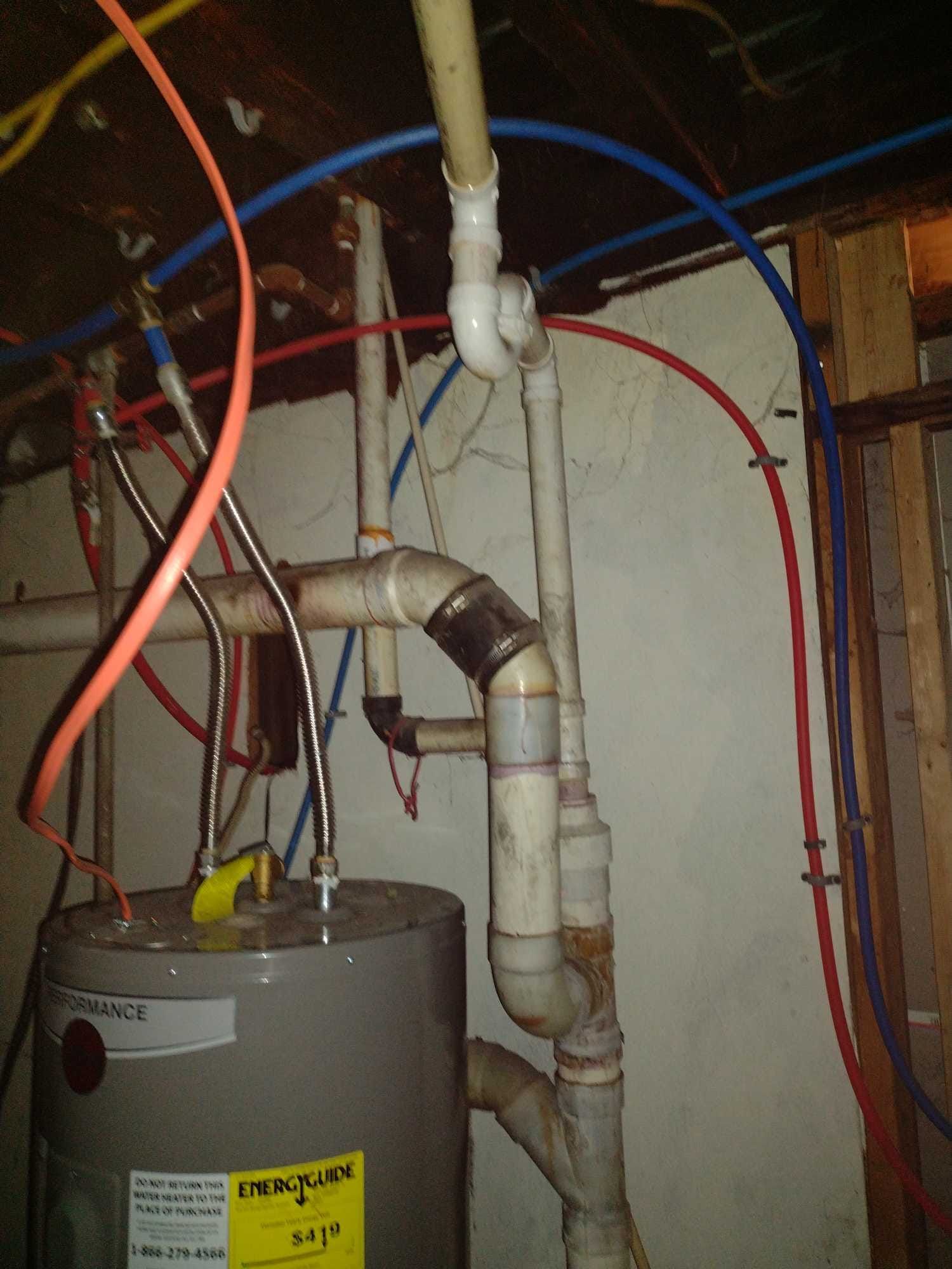 A water heater has a yellow sticker on it that says energy saver