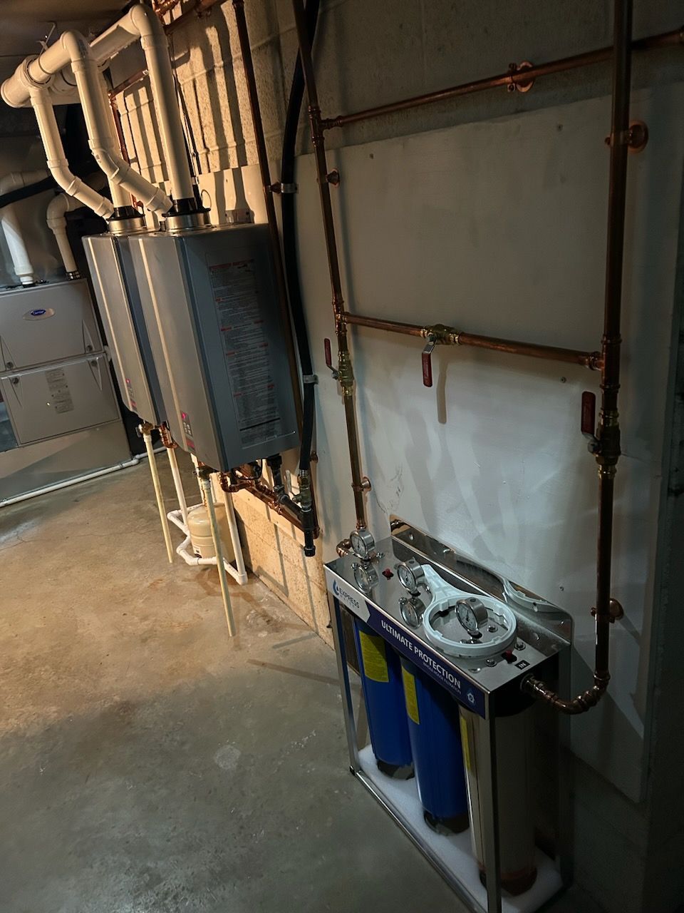 A room with a lot of pipes and a sink.