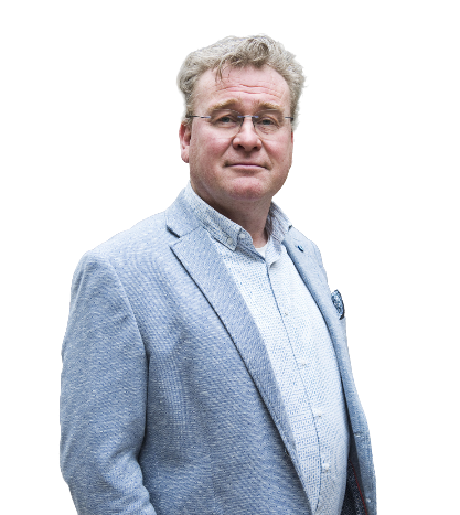 Man in blue blazer and patterned shirt, looking forward, slightly smiling.