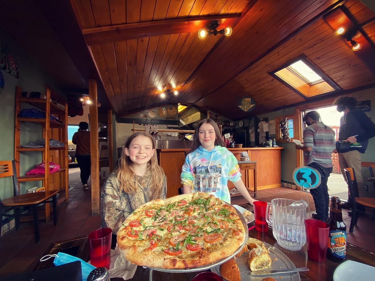 Two girls with a pizza at High Mountain Pies