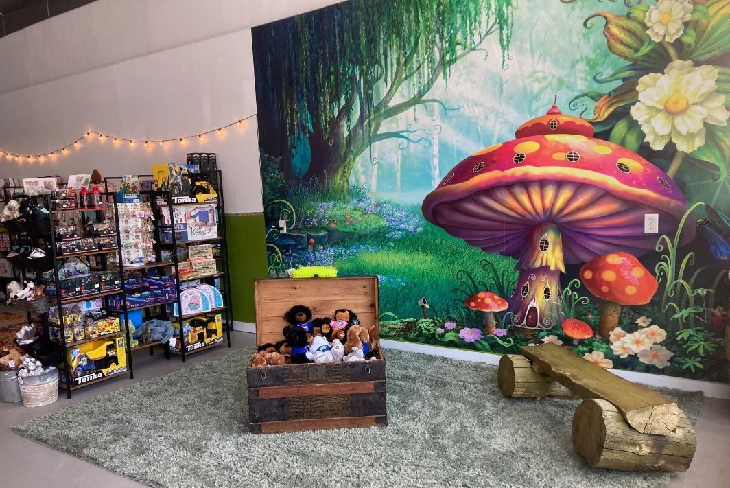 Painting of a whimsical mushroom next to display of toys