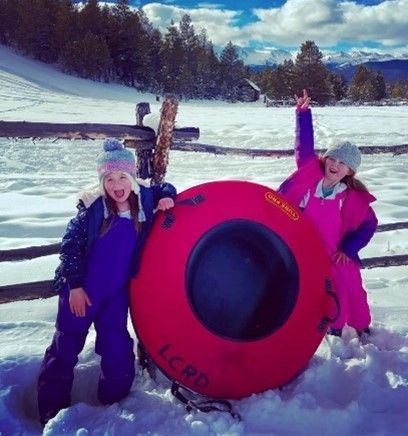 Tow children with a snow tube at Dutch Henry Sledding Hill