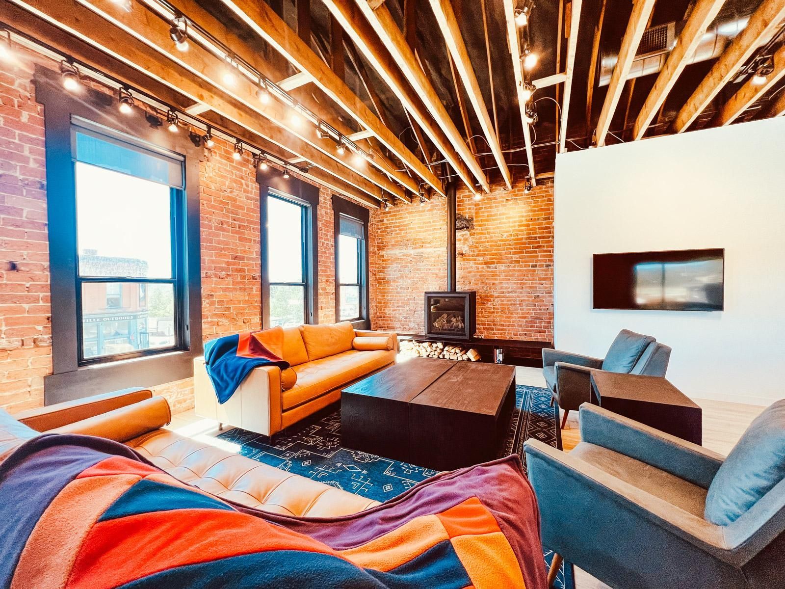 Loft with windows and fireplace at Timberline Motel