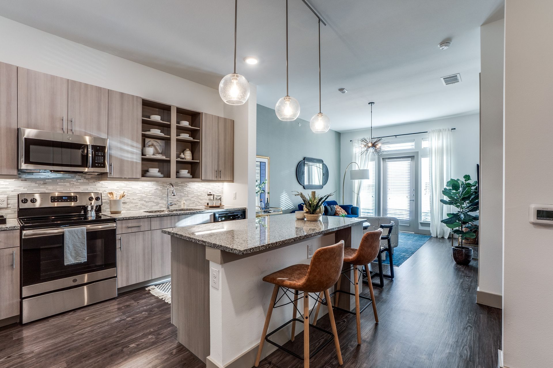 A kitchen with stainless steel appliances and granite counter tops.