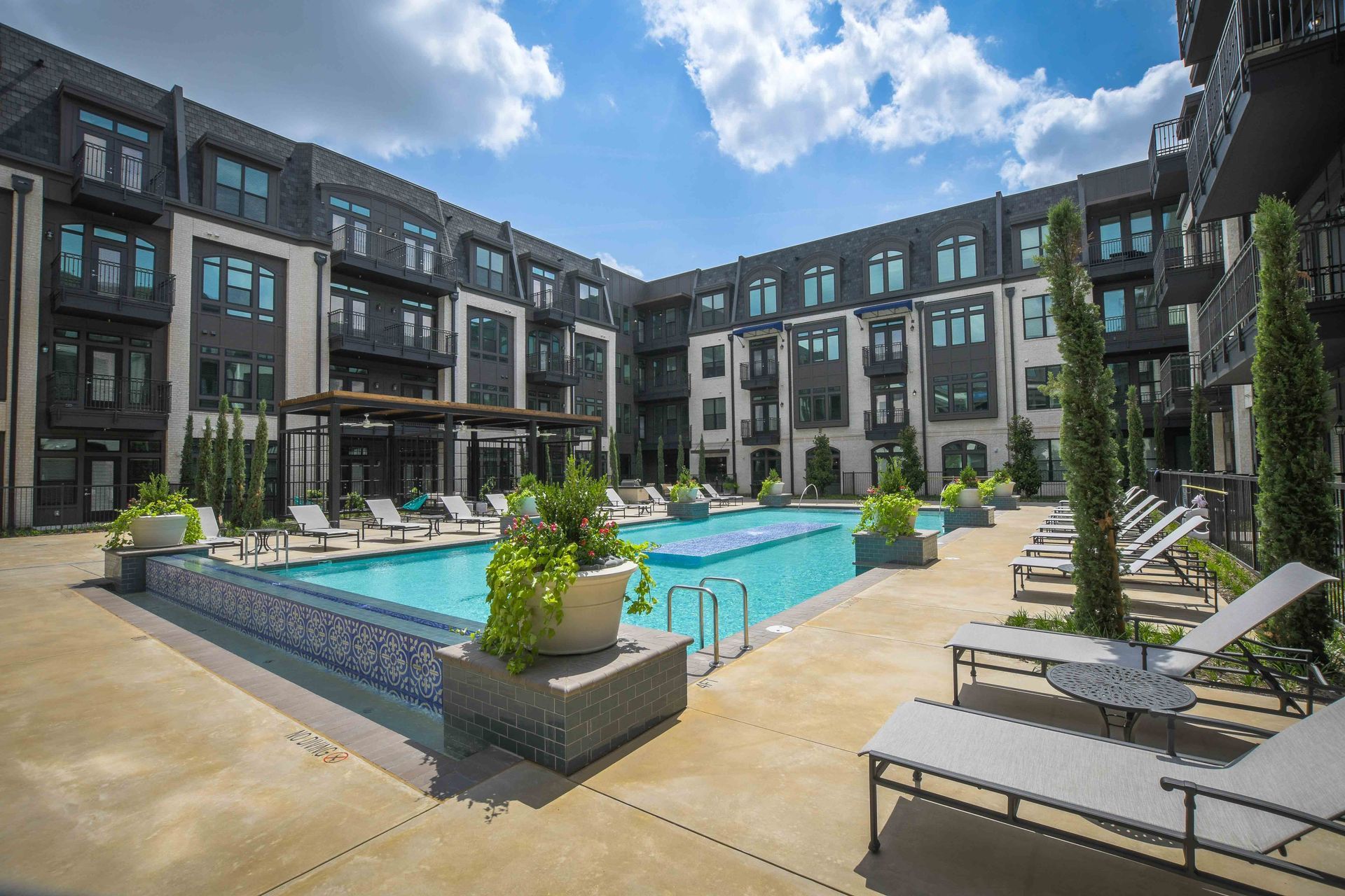 There is a large swimming pool in the middle of a building.