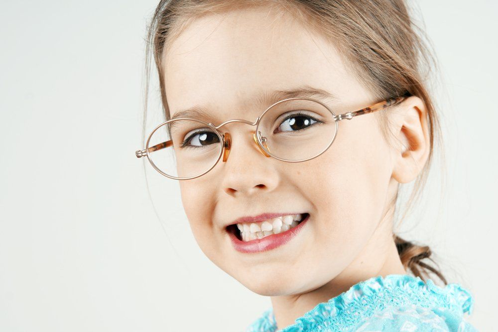 portrait of a beautiful girl wearing tiny glasses