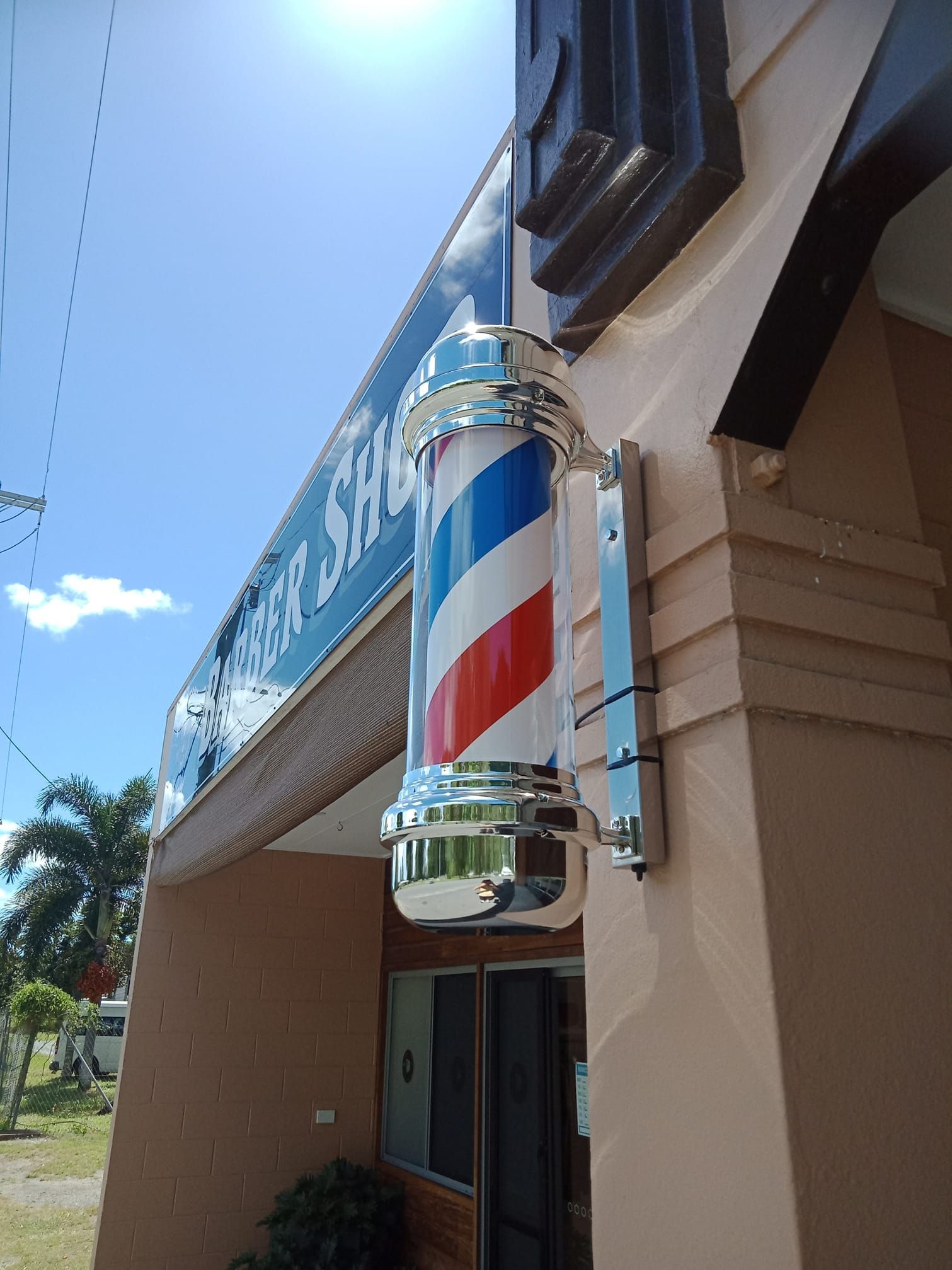 Barber Shop Sign With Rotating Red, White, and Blue Stripes — Eagle Tamer Barbershop in Stratford, QLD