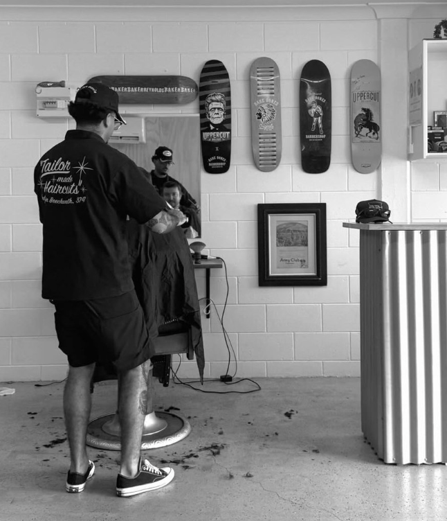Barber Giving a Man a Haircut With Clippers in a Salon — Eagle Tamer Barbershop in Stratford, QLD