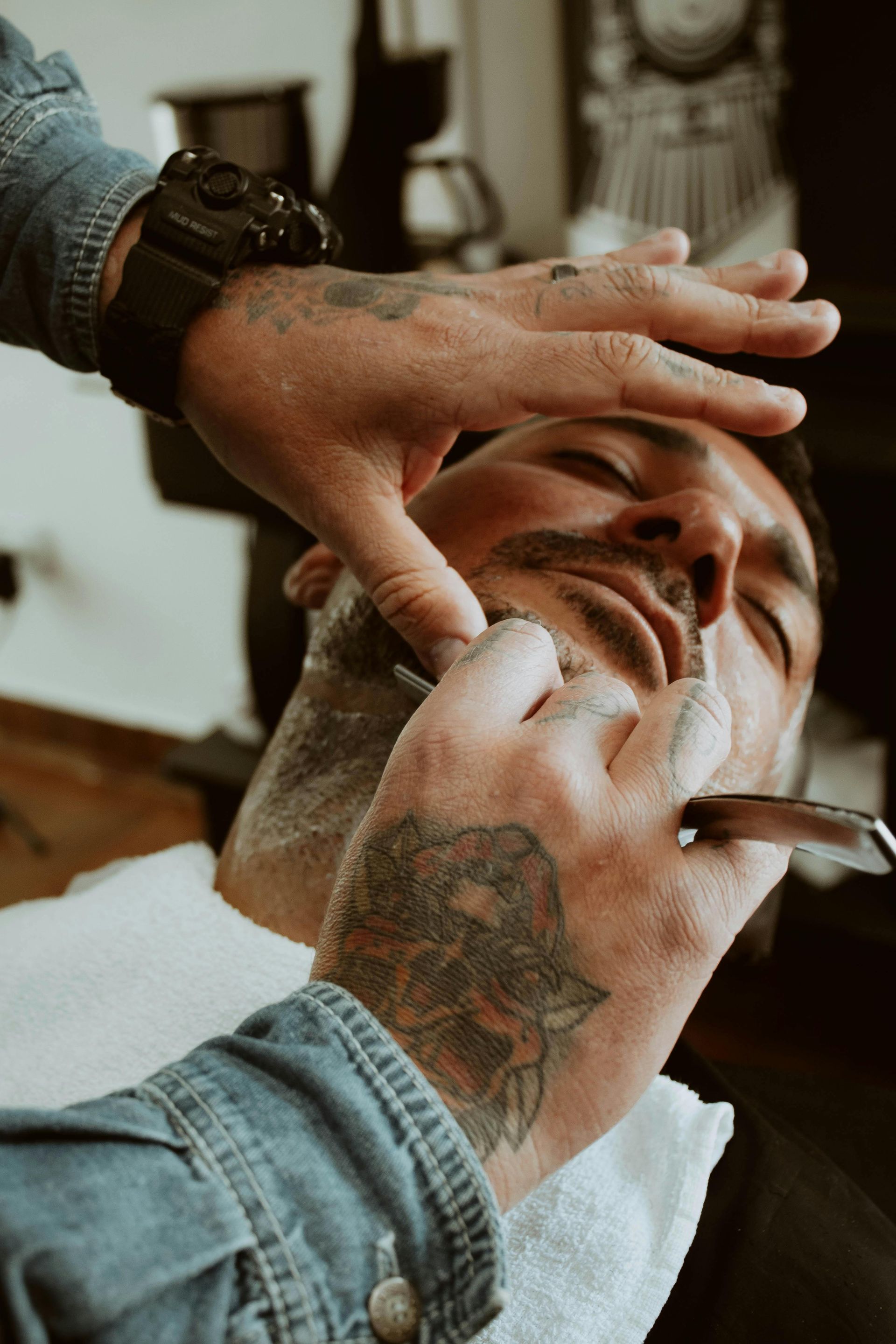 Barber Shaving a Man's Neck With a Straight Razor — Eagle Tamer Barbershop in Stratford, QLD