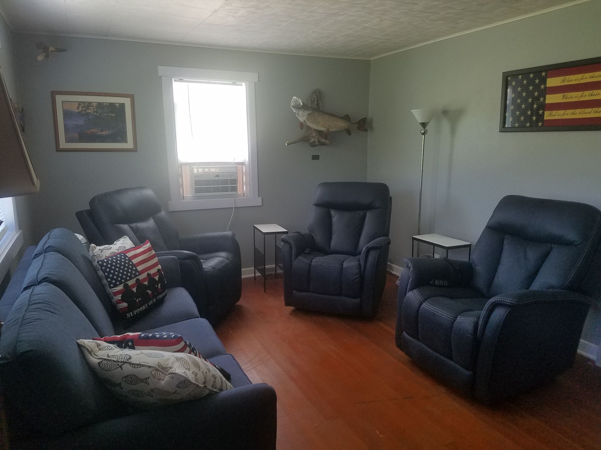 A living room with a couch and two chairs
