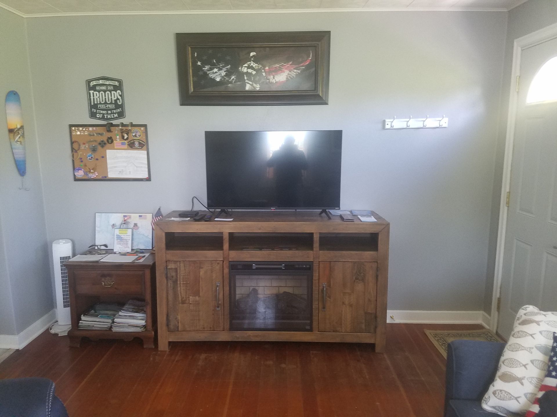 A living room with a fireplace and a flat screen tv