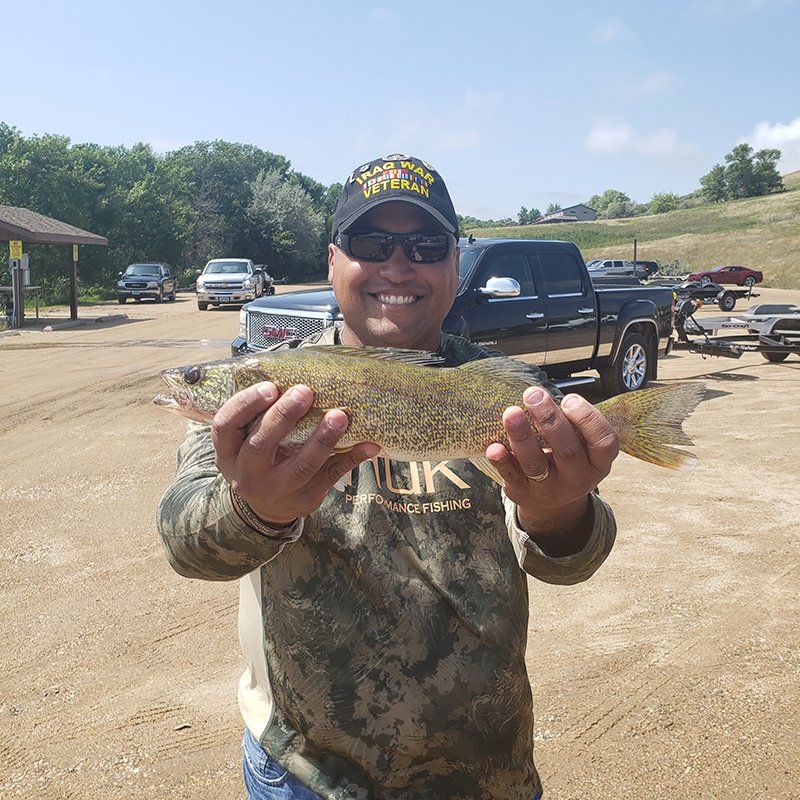 man holding a walleye