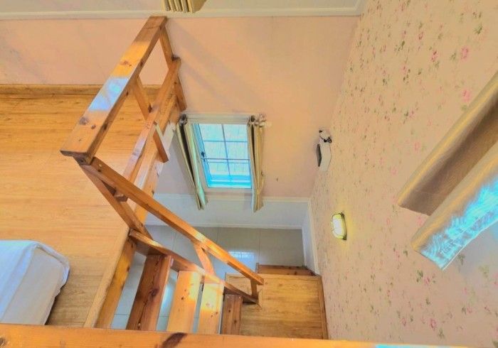 A wooden staircase leading up to the second floor of a house.