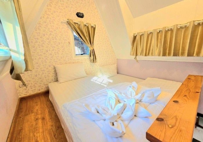 A bedroom with a bed and a wooden table.