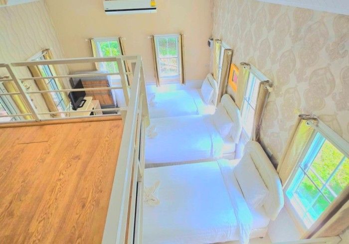 An aerial view of a bedroom with a staircase leading to the second floor.