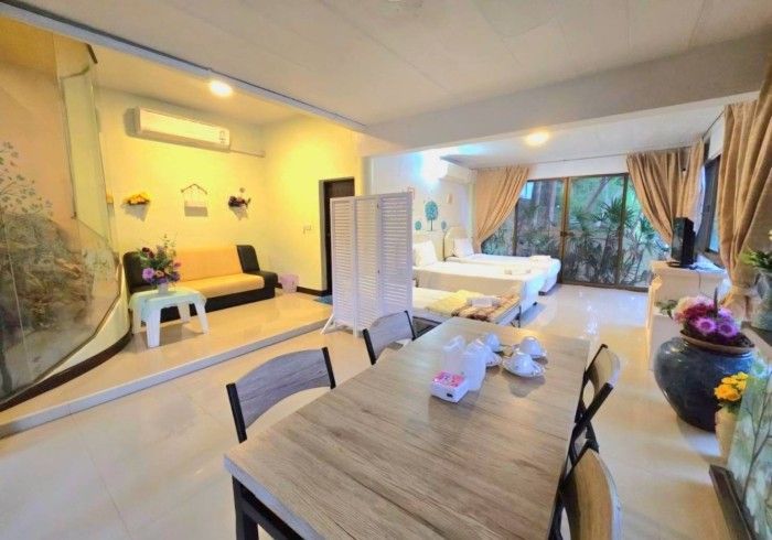 There is a table and chairs in the middle of the room.