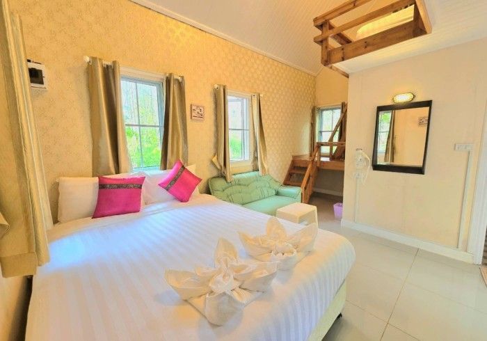 A bedroom with a bed , couch , and bunk bed.