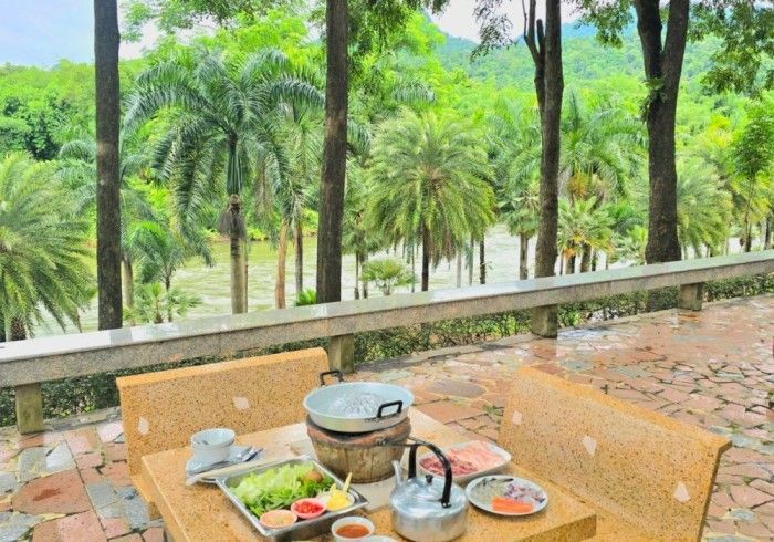A table with a lot of food on it and a view of a forest.