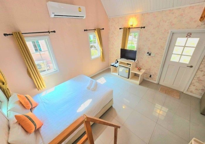 A bedroom with a king size bed and a television