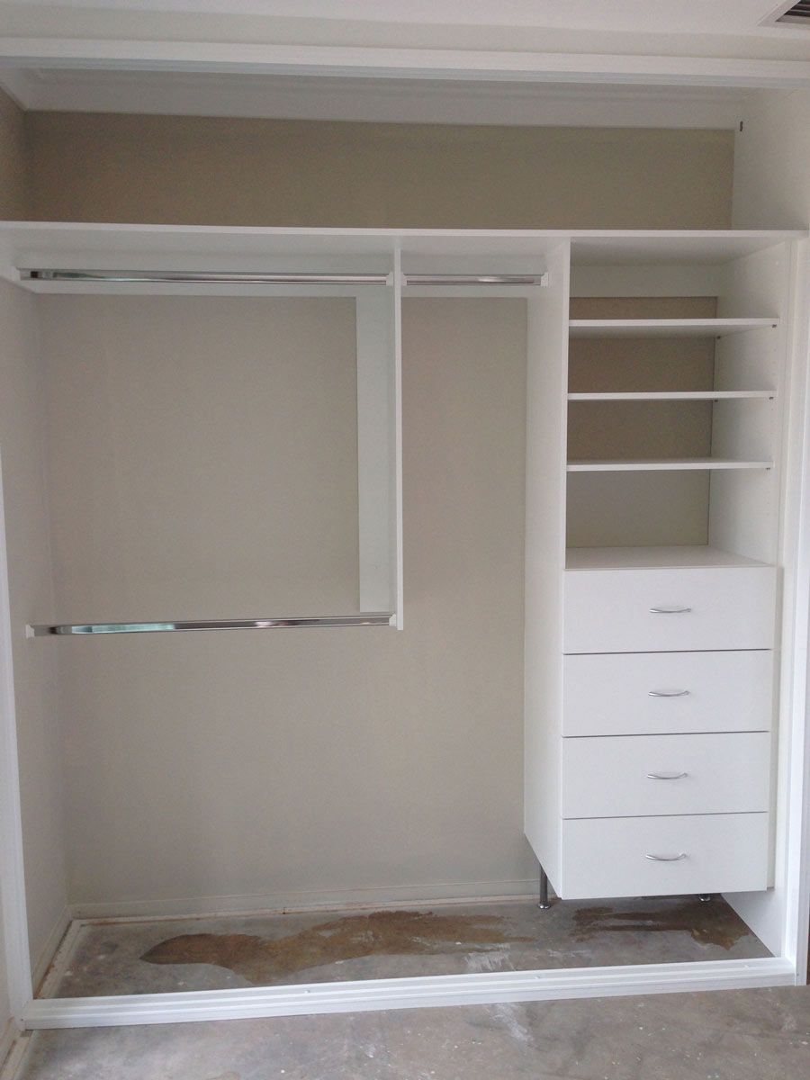 corner of white shelving to walk in wardrobe