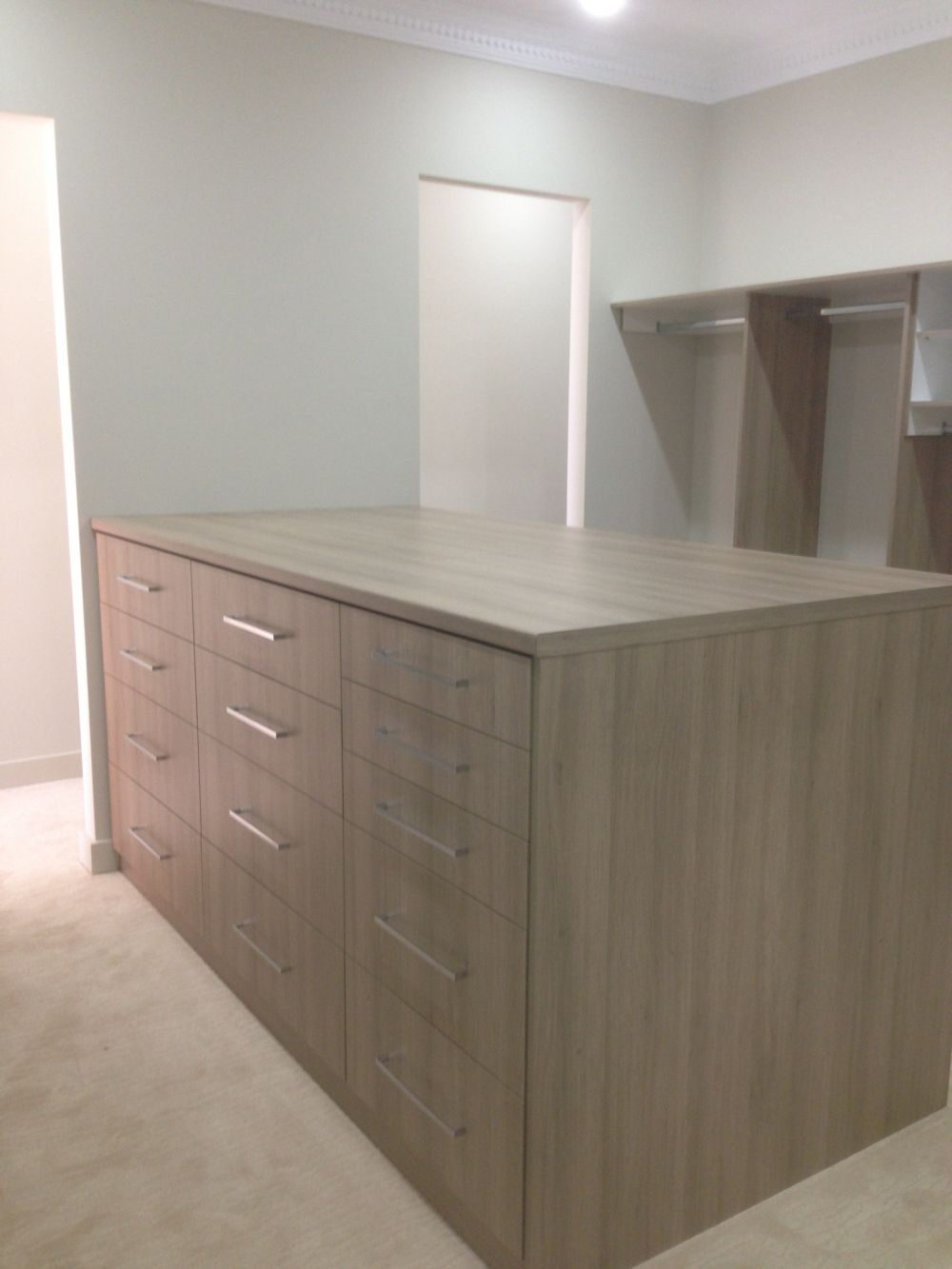 another angle of the island dresser in walk in wardrobe