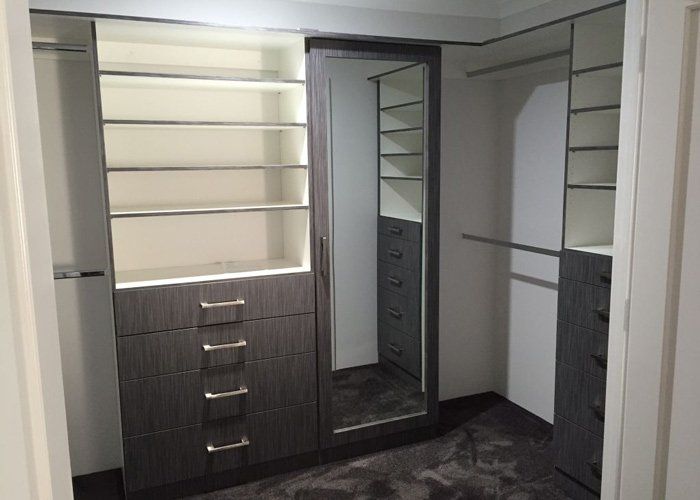 wardrobe interior with mirror and stacked shelves