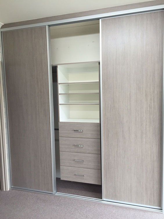 light brown sliding doors showing cupboards inside