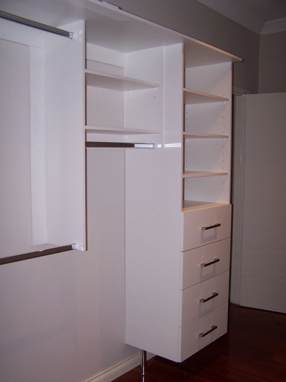 white wood and metal handled walk in wardrobe