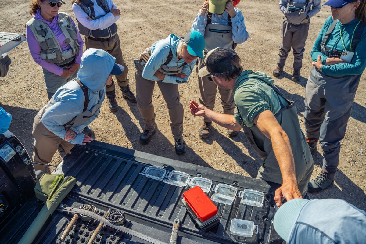 A group of people are standing around a truck.