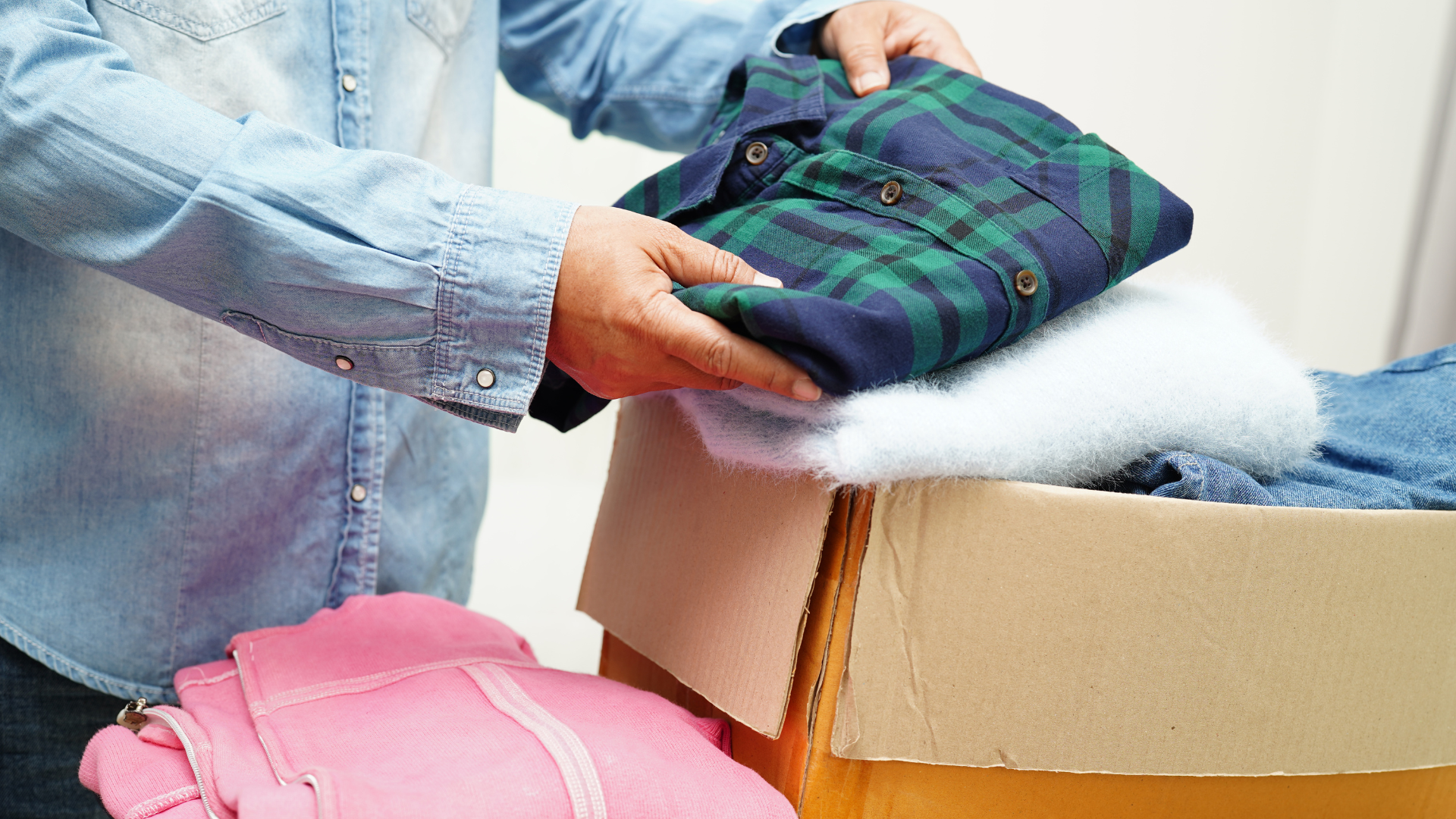 A mannequin is wearing an orange shirt with black buttons