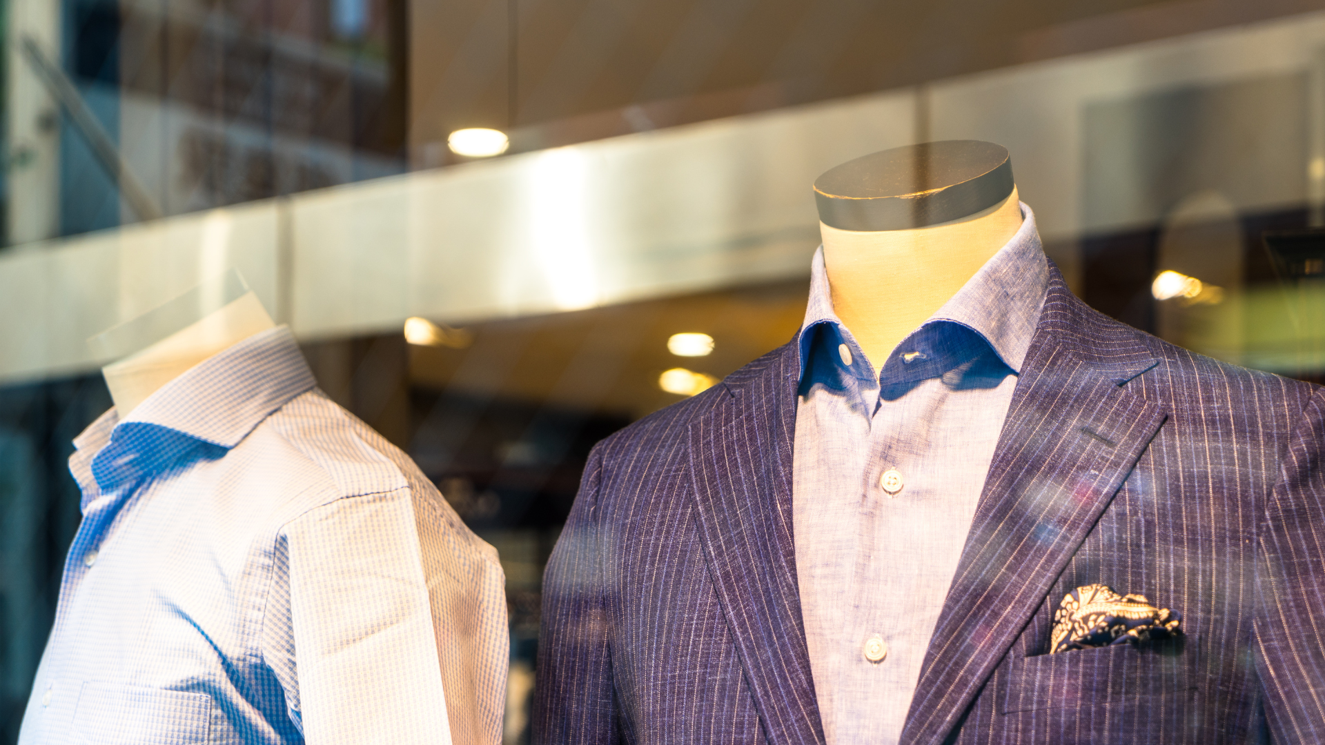 A man is adjusting his jacket with his hands.