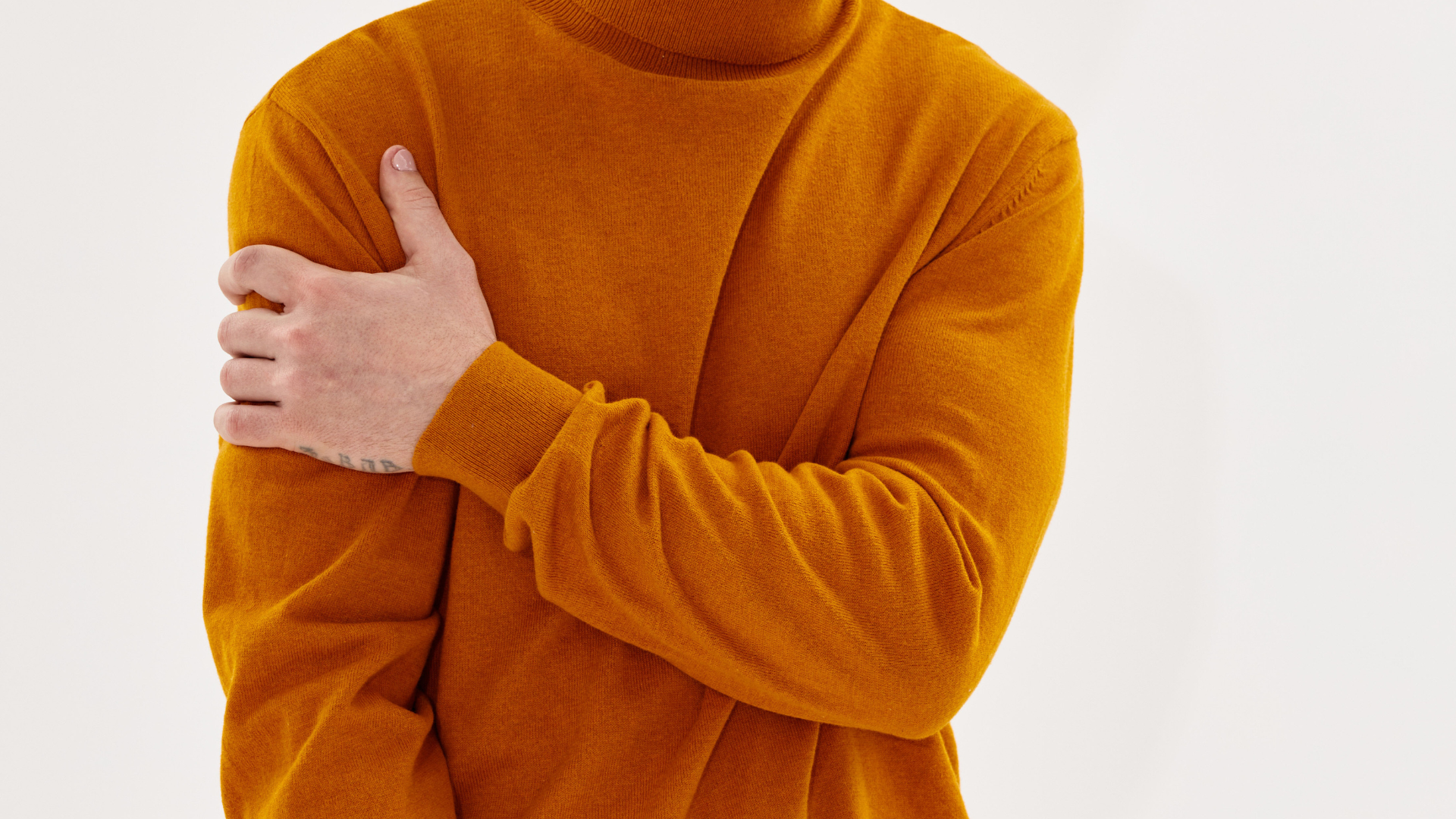A man wearing sunglasses and a plaid suit jacket