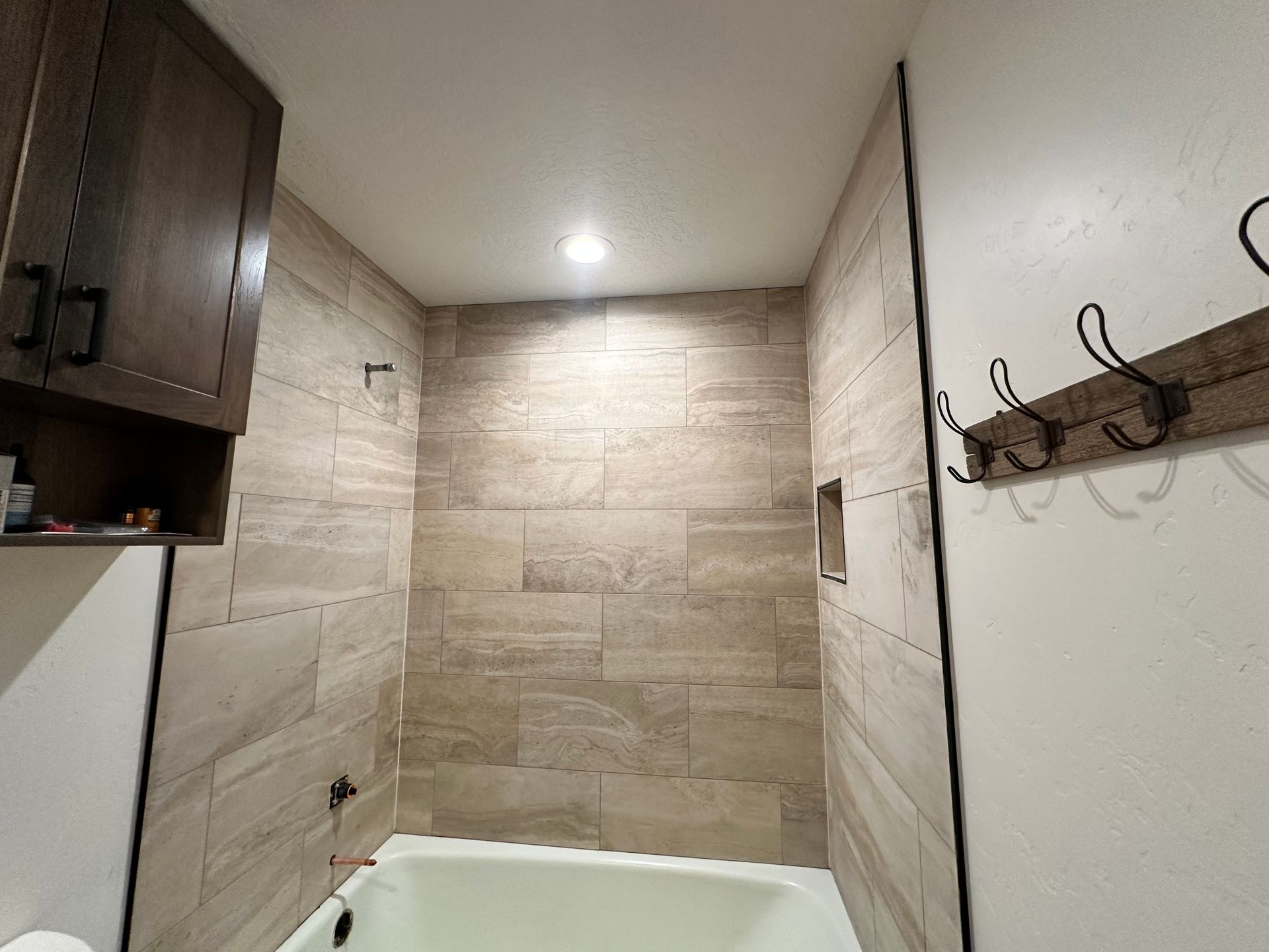 A bathroom with a bathtub and a shower.