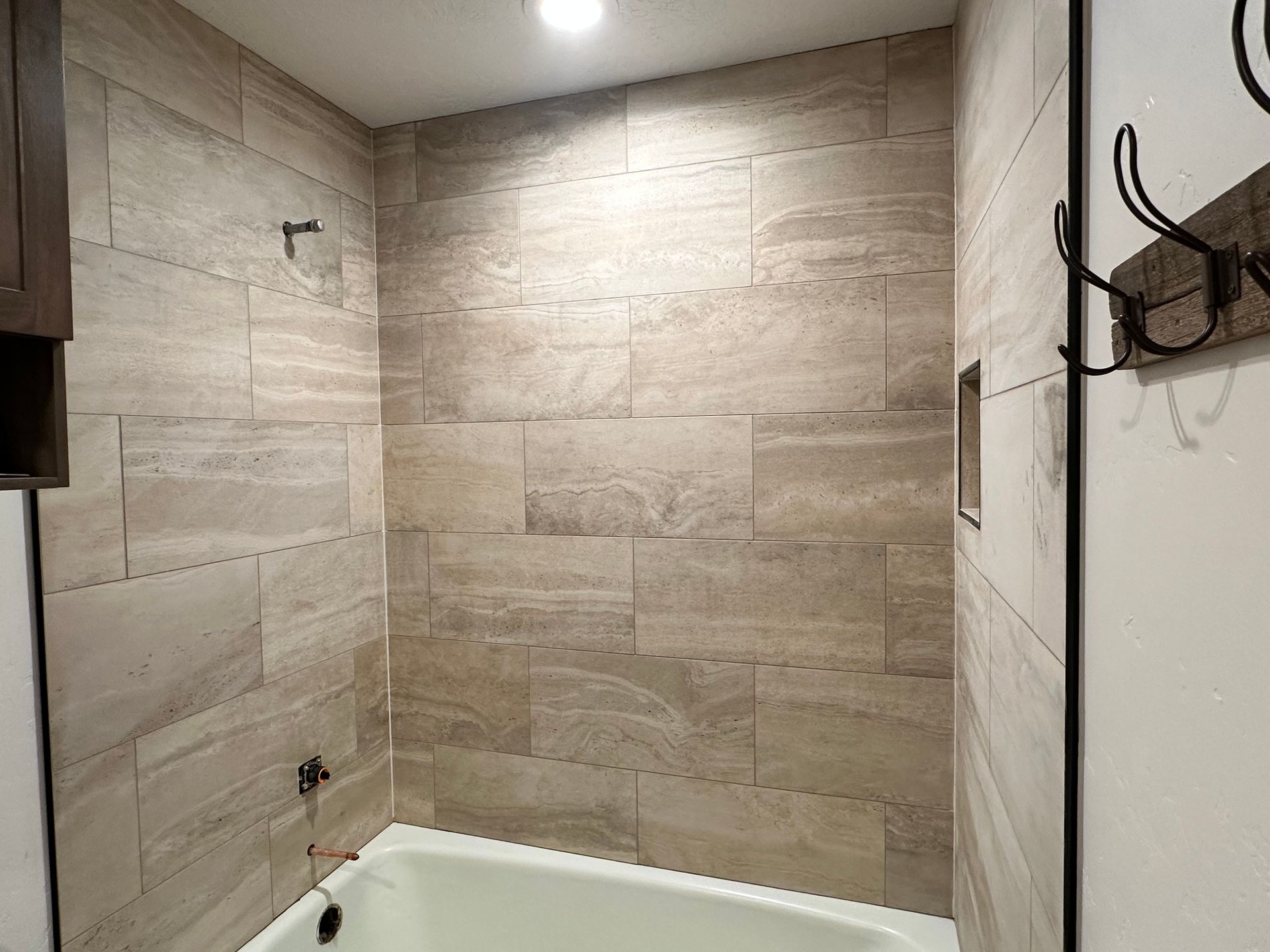 A bathroom with a bathtub and a shower.