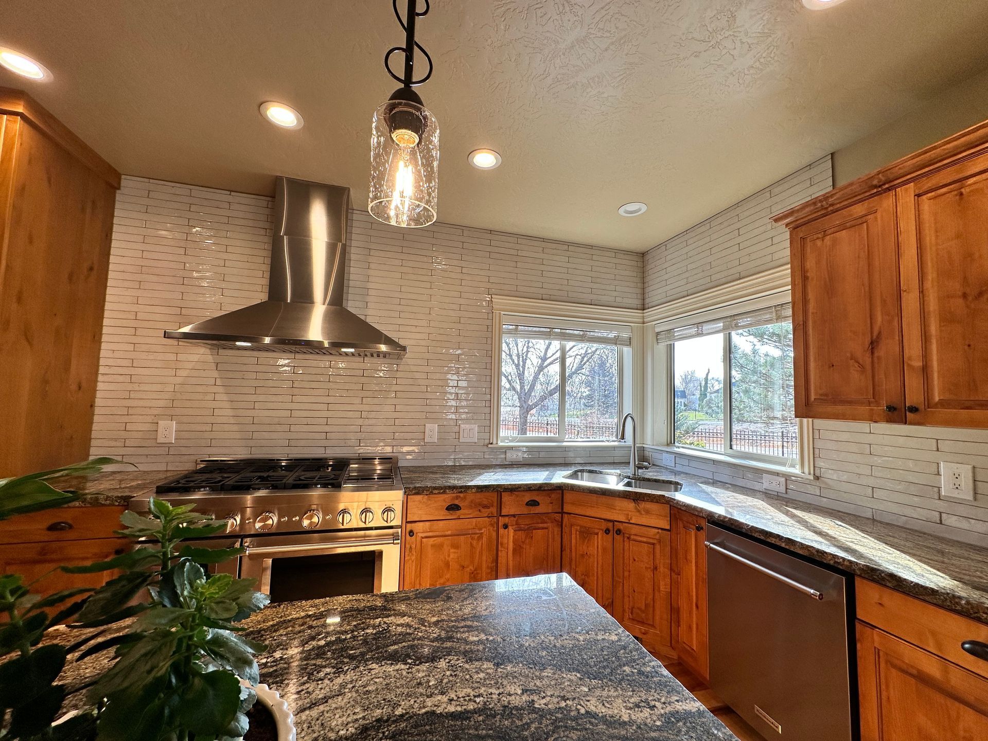 A kitchen with stainless steel appliances and wooden cabinets