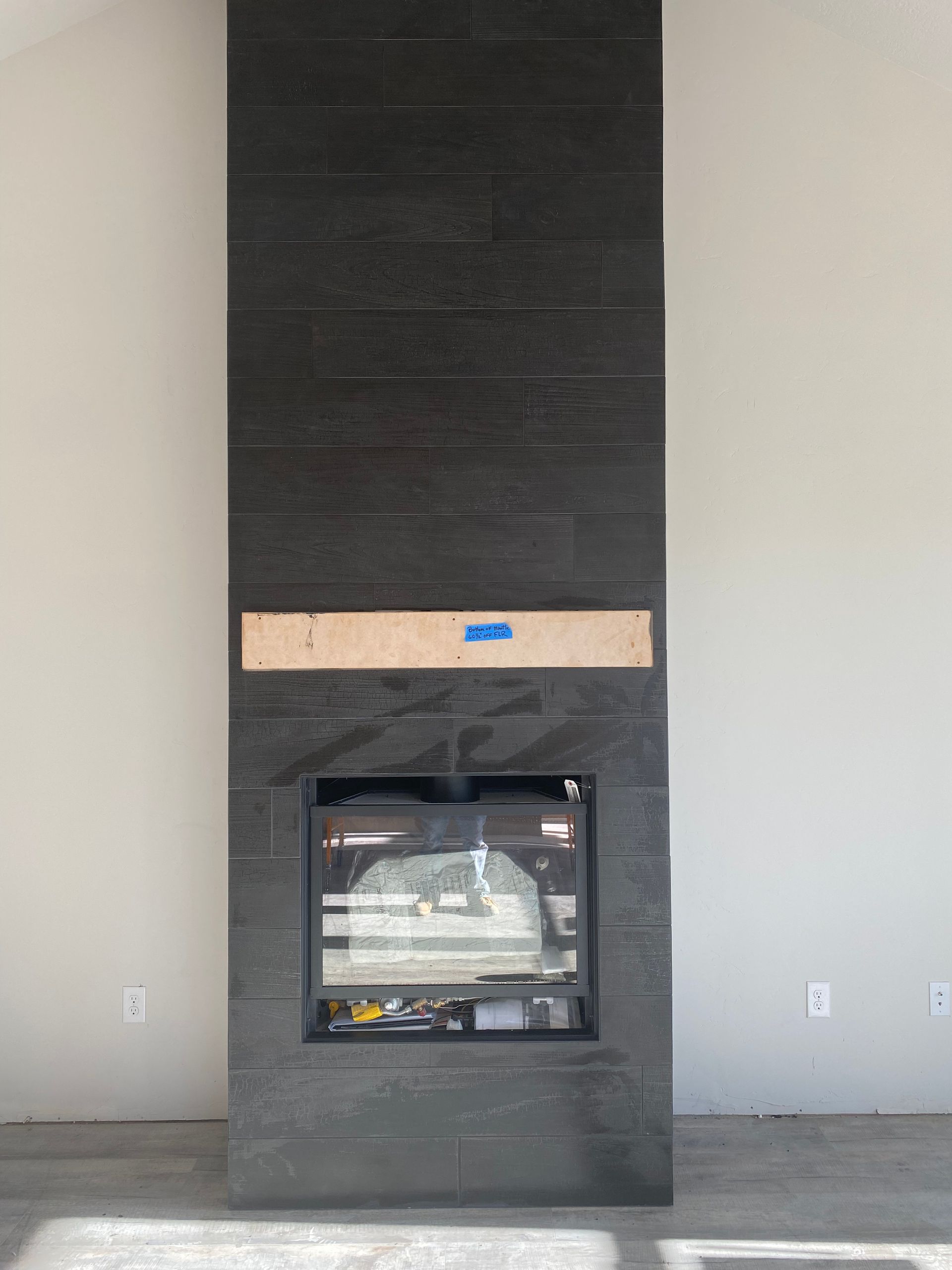 A fireplace is being built in a living room in a house.