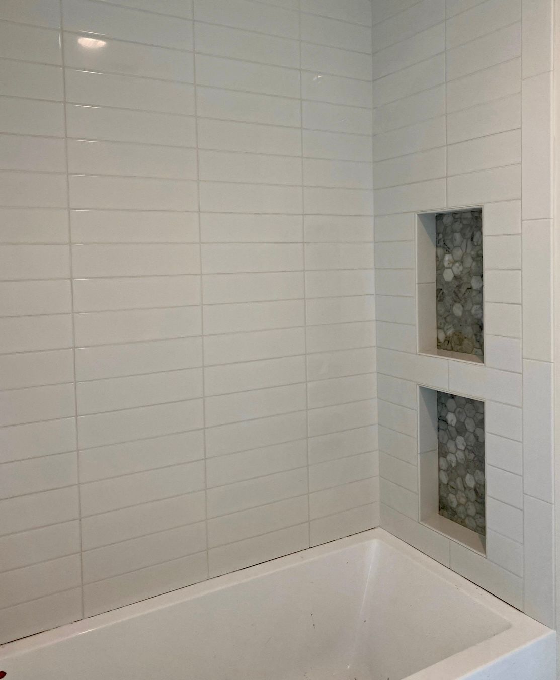 There is a bathtub in the corner of the bathroom.