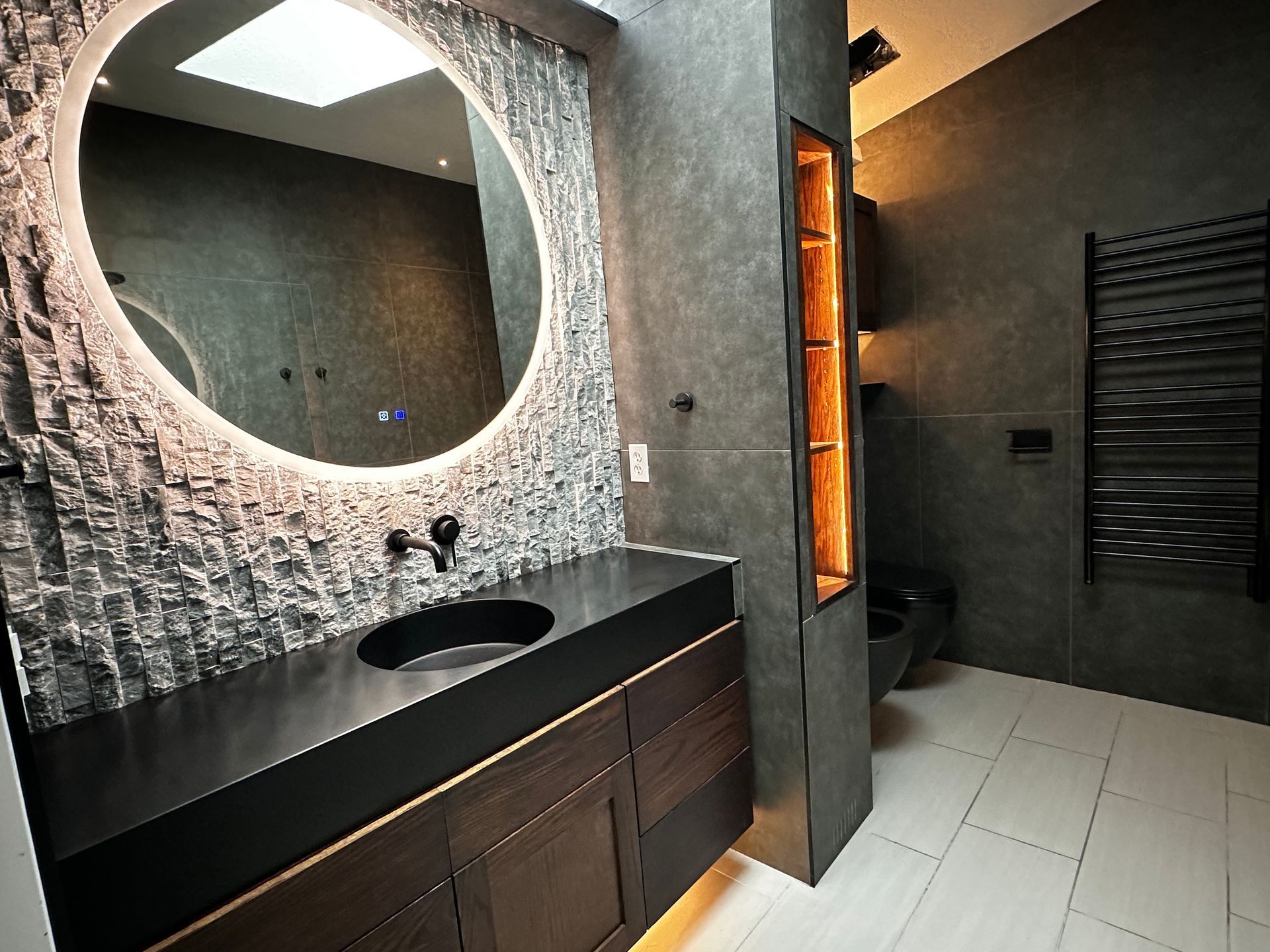 A bathroom with a sink , mirror and toilet.