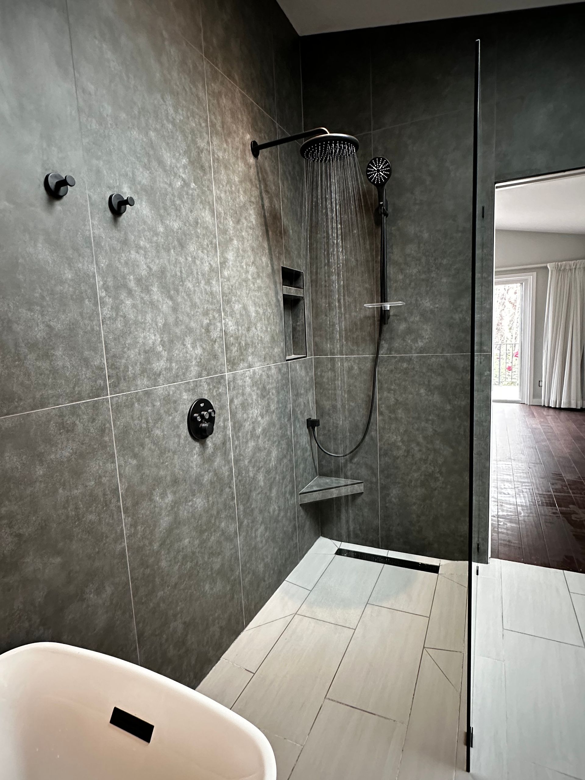 A bathroom with a bathtub and a shower.
